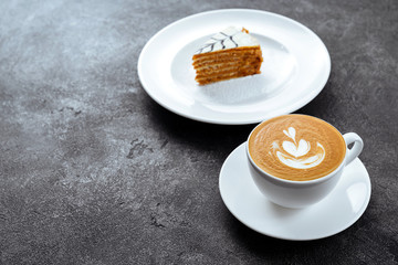 Poster - cup of coffee and cake on black stone background Top view