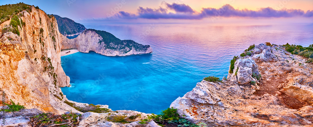Obraz na płótnie Navagio Beach with shipwreck view on Zakynthos island, Greece. Incredibly romantic sunrise on Zakinthos. Amazing sunset view with multicolored clouds. Island of lovers. Doors to heaven w salonie