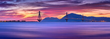 Sunset View On The Bridge Near Patras. Suspension Bridge Crossing Corinth Gulf Strait, Greece, Europe. Second Longest Cable-stayed Bridge In The World. Dramatic Red Sky Under A Rion-Antirion Bridge.