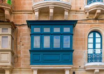 Wall Mural - Typical narrow streets with colorful balconies at traditional buildings in Valletta, capital of island of Malta, Europe