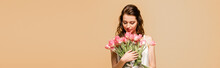 Panoramic Shot Of Happy Girl Holding Pink Tulips Isolated On Pink