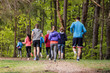 © Halfpoint - Rear view of large group of multi generation people running in nature.