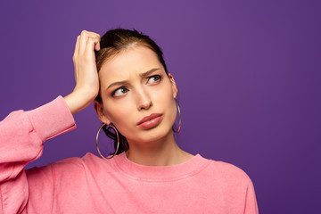 Wall Mural - thoughtful girl looking away while touching head isolated on purple