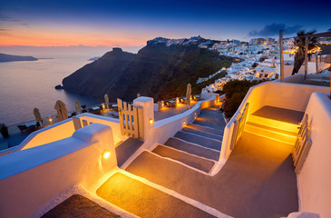 Fira town on Santorini island, Greece. Incredibly romantic sunset on Santorini. Oia village in the morning light. Amazing sunset view with white houses. Island lovers