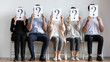 © fizkes - Diverse employees hold sheets with question marks wait for interview