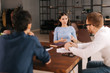 © dikushin - Woman job seeker at interview, girl answers interviewer's questions in modern office room. Young serious woman is having working conversation with her male colleagues.Concept of office life.