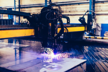 Wall Mural - Flame cutting process with steel profiling machine in a factory