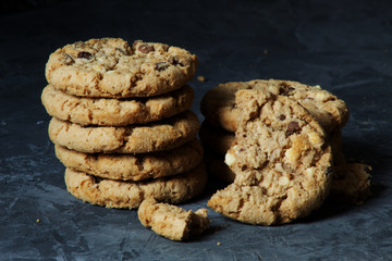 Fresh chocolate chip cookies with chocolate on a dark background food sweet