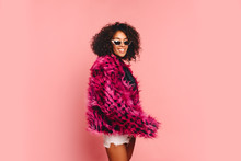 Black Woman In A Black Faux Fur Jacket, Close Up Fashion Portrait Of Crazy Hipster African Girl With Funny Curly Hairstyle And Vivid Faux Fur Coat, Urban Trendy Style. Horizontal.copy Space