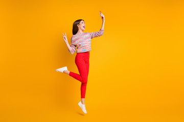 Sticker - Full size photo funny girl relax fall holidays take selfie smartphone make v-signs video call bloggers influencers wear red pants trousers shoes isolated bright shine yellow color background