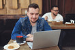 © Kseniia - Man with laptop in cafe. Business lunch.