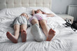 © Kiryakova Anna - Two girls are lying on the bed. The older sister has a leg in a cast. Medical concept