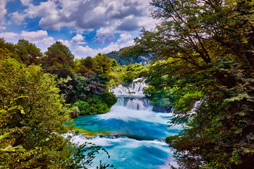 Wall Mural - Beautiful Skradinski Buk Waterfall In Krka National Park - Dalmatia Croatia, Europe. Beautiful long exposure panorama of waterfalls (milk effect). A true natural wonder. Amaizing sunlight view.