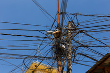 The Chaos Of Cables And Wires In Kathmandu, Electric And Telephone Wires Wound On A Lamppost. Nepal