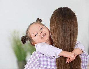 Canvas Print - Young mother with little daughter at home. Space for text