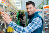 Fototapeta  - male customer buying working tools in supermarket