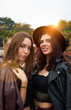 © Indico Studio/ADDICTIVE STOCK - Charming long haired stylish girl friends confidently looking at camera in bright day at festival