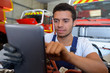 young fire service mechanic looking at tablet
