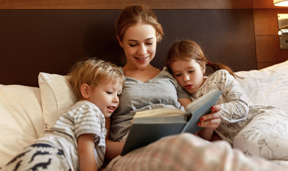 Wall Mural - evening family reading. mother reads children . book before going to bed .