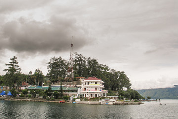 volcanic island of samosir on the lake of toba, on northern sumatra, visible typical houses and chri