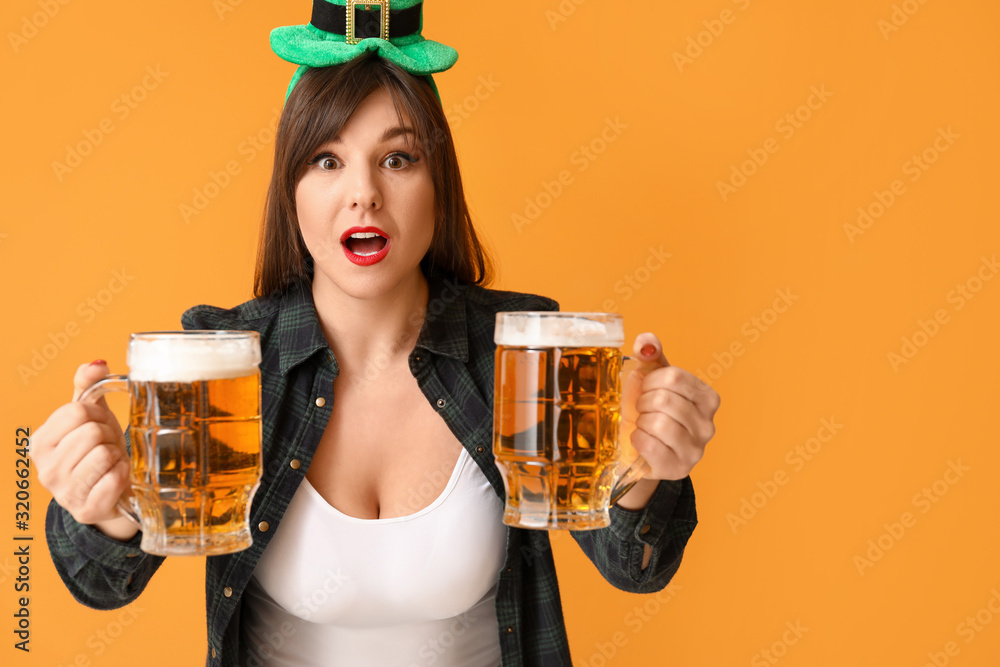 Funny young woman with beer on color background. St. Patrick's Day celebration