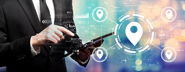 Map pin concept with businessman using his tablet computer