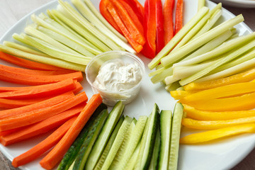 Wall Mural - Sliced cucumbers, carrots, celery, peppers on a plate