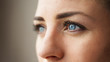 © Artem - blue eyes of a young beautiful girl. macro eye photo. expressive pretty face on gray bokeh background. girl looks into the distance