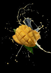 Wall Mural - mango slice and mango juice splash wave isolated on a black background