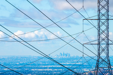 Wall Mural - Los Angeles skyline behind power tower and power lines on a blue cloudy day