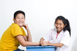 © nuiiko - Asian children playing doctor at home, girl doctor checking up her patient.