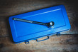 © SKatzenberger - A socket wrench on a blue tool box