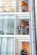© pressmaster - Modern young multi-ethnic employees of business center working with each other on different floors