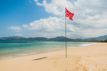 Red Warning Flag On A Beautiful Tropical Empty Beach Of Indonesia