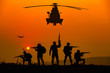 © AU USAnakul - Silhouette of military rangers and Helicopter with soldier on the top of mountain at sunset