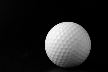 Wall Mural - Golf ball close up on black background