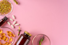 Herbs And Herbal Dietary Supplements Top View On Pink Background
