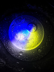 bubble oil on the water look like planet in the space, with colour full light in dark background.