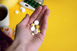 © iama_sing - A man holds in his hand a portion of pills for treatment.
