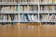 © wachiwit - Wooden table with bookshelves in library