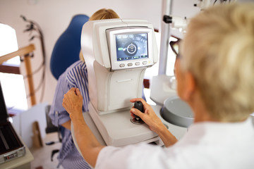 Wall Mural - Optometrist examining patient in modern ophthalmology clinic