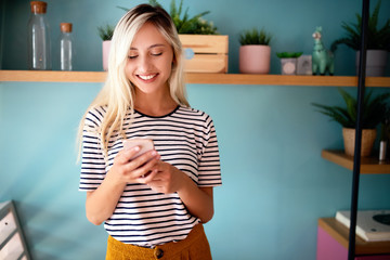 Wall Mural - Young beautiful women touching and browsing her smart phone