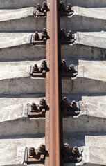 Wall Mural - Rusty rail on concrete sleepers. Vertical photo