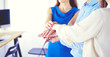 © lenets_tan - Business colleagues stacking hands together at office