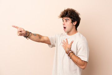 Young caucasian man over isolated background pointing finger to the side