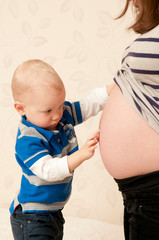 Belly of a pregnant woman and a boy