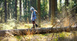 © MNStudio - Cute little girl having fun during forest hike on beautiful spring day. Child exploring nature.