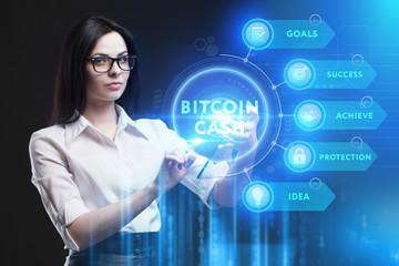 Business, Technology, Internet and network concept. Young businessman working on a virtual screen of the future and sees the inscription: Bitcoin cash