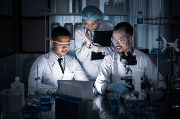 Wall Mural - team of medical research scientists collectively working on a new generation experimental drug treat