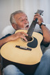 © chokniti - The old man and his guitar in the house